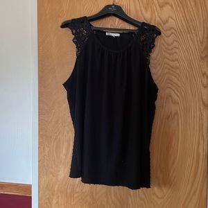 Plus size top with lacy shoulder detail.